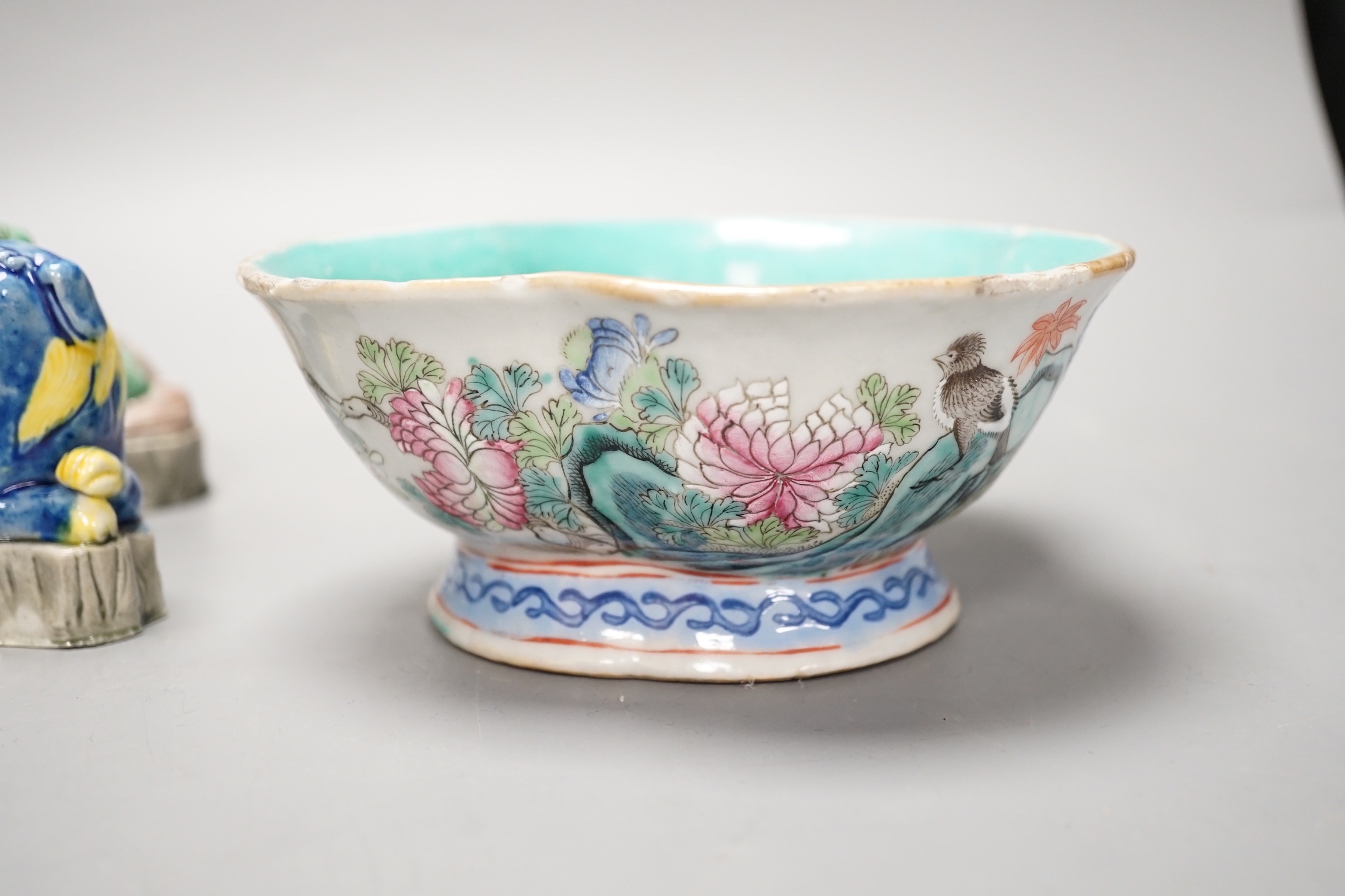 Four Chinese polychrome glazed models of lion-dogs, Republic period and a Chinese famille rose dish, Tongzhi mark, 15.5cm (5)